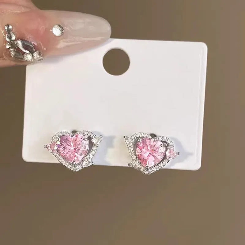 A pair of heart-shaped stud earrings with a white gold colour finish.
