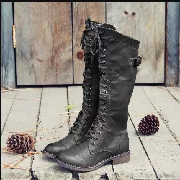 Black chunky heel high leg boot with round toe and low rubber sole