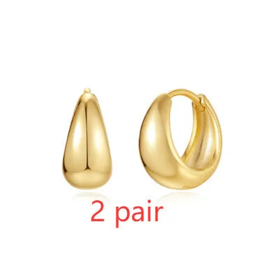 Golden brass diamond earclip earrings with simple geometric round design on white background