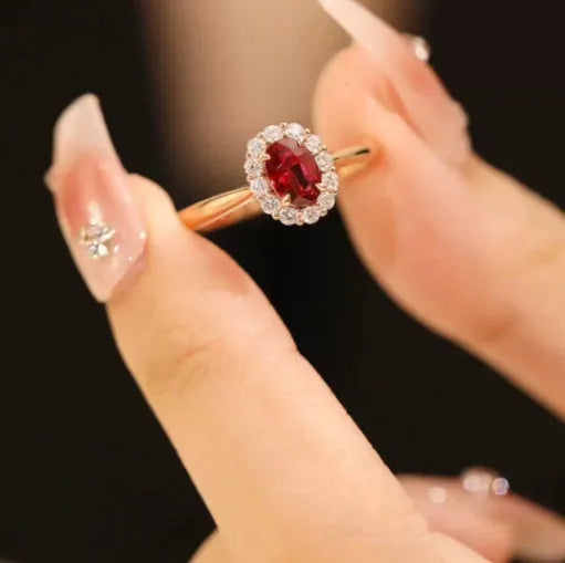 Gold Pigeon women's silver ring with red gemstone and floral gold inlaid pattern.