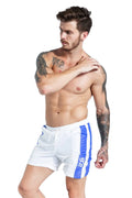 Men's blue sports shorts with lace-up front and slim fit, shown on a model.