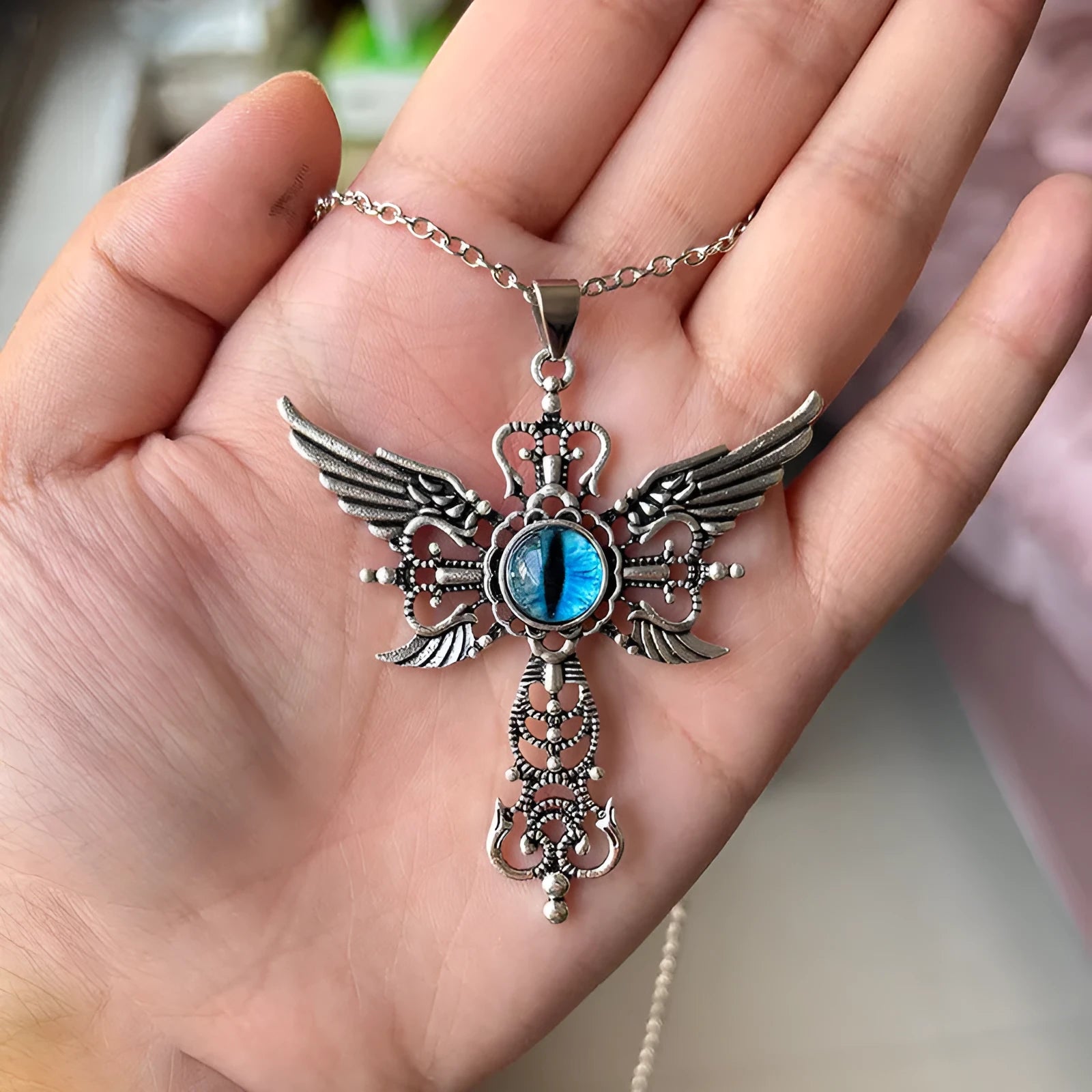 Alloy devil wings and cross geometric pendant necklace on a chain in blue, green, purple, red, and yellow colour options.