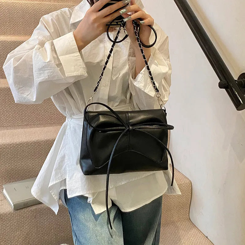Women's black PU leather crossbody bag with square shape and sewing line detailing
