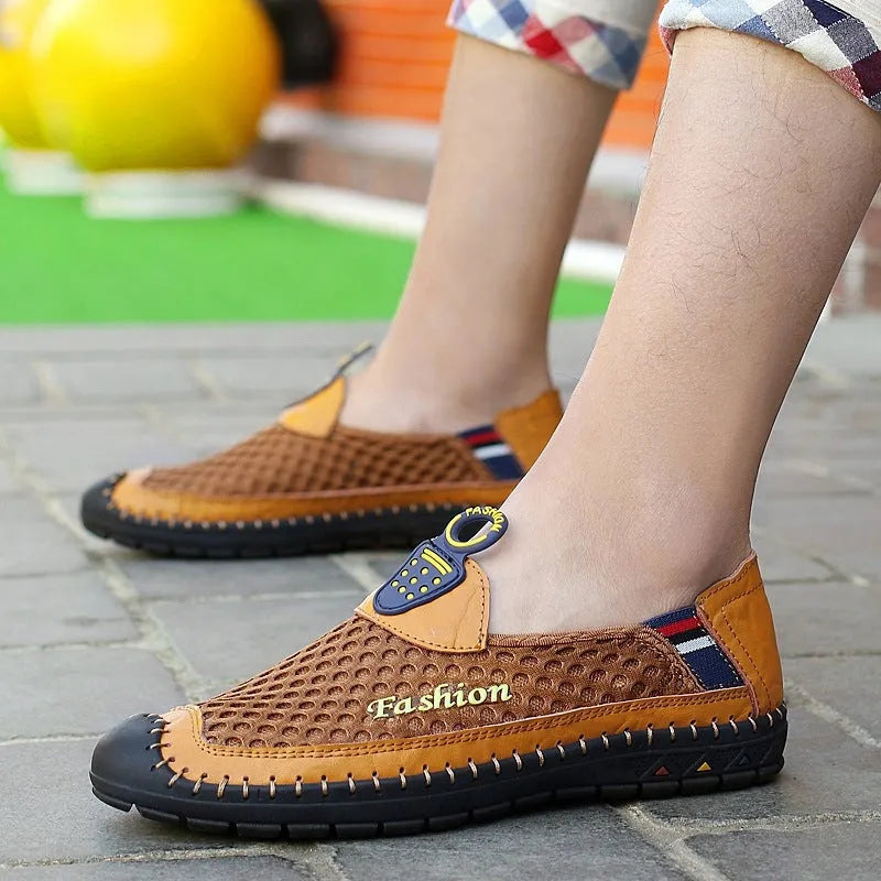 Men's brown casual shoes with mesh fabric upper and rubber sole, showing round toe and shallow-cut design.