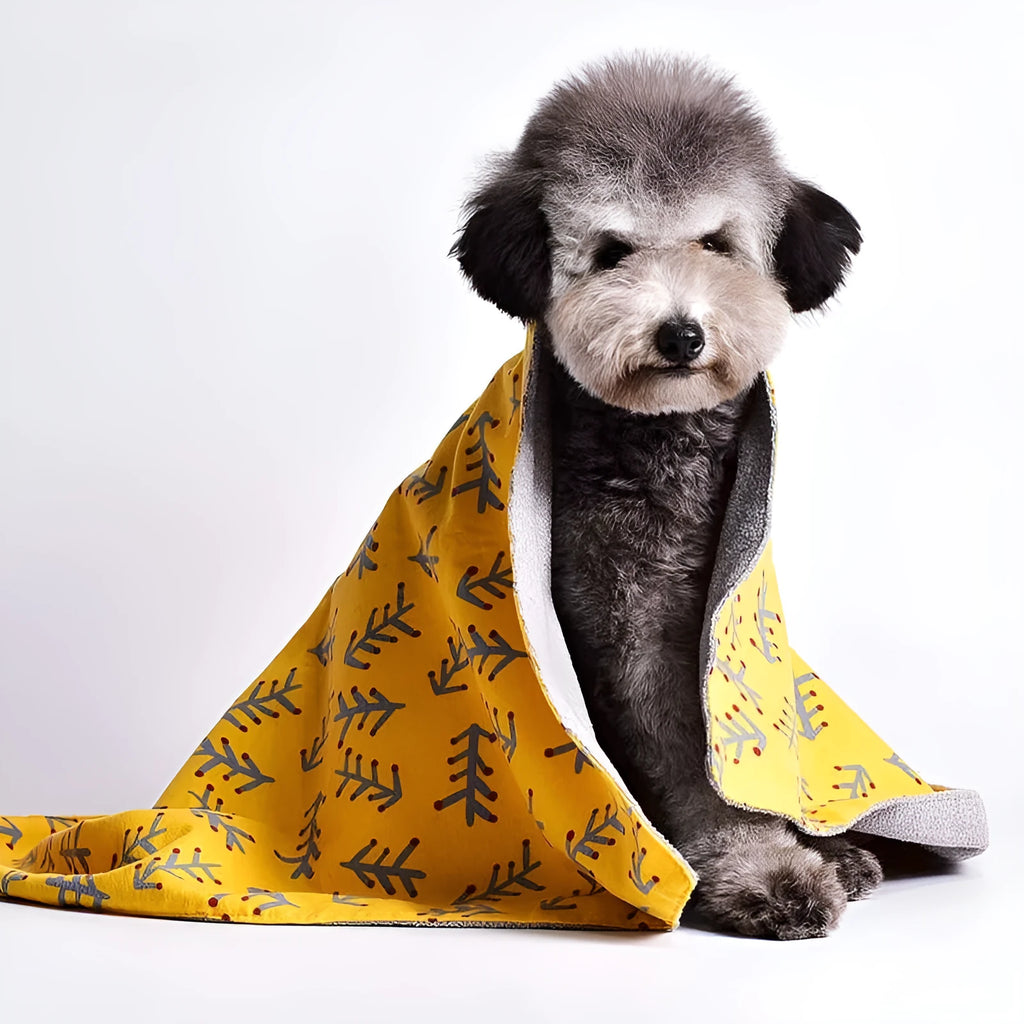 Double-sided cotton fleece pet blanket showing dinosaur print design, folded to show soft texture.