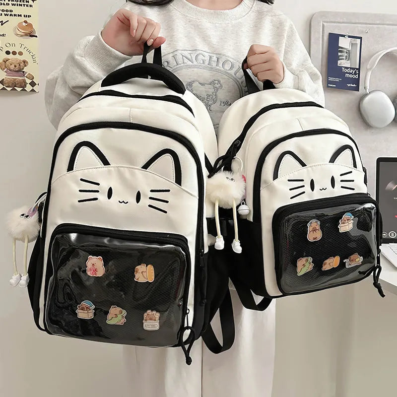 Cartoon style large capacity nylon backpack in pink with badge pendant, showing curved shoulder straps