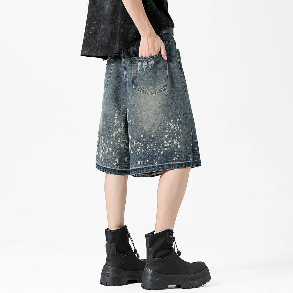 Men's retro blue washed denim shorts with ripped splash ink detailing, straight cut design
