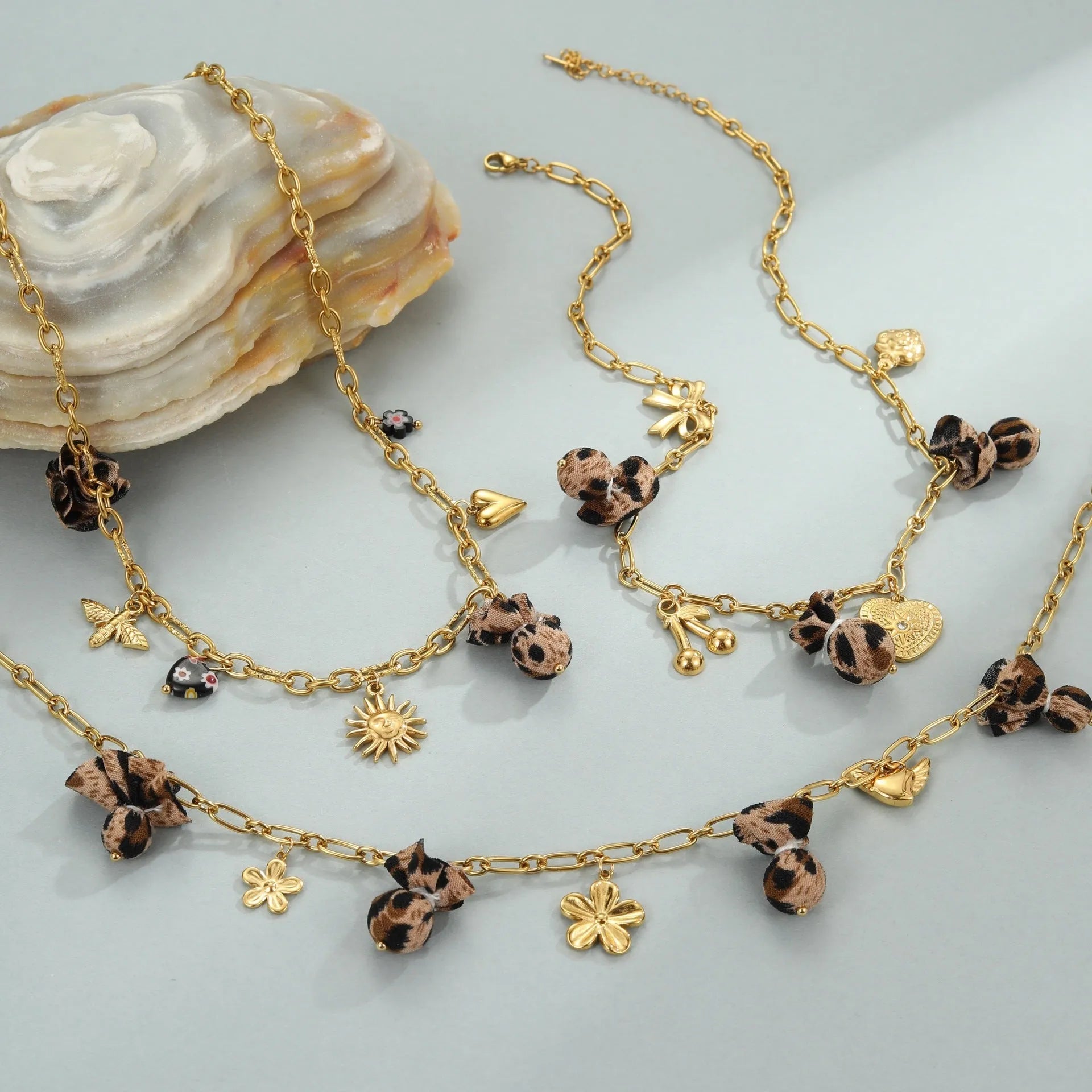 Women's stainless steel necklace with geometric leopard pendant featuring love heart and floral details on adjustable chain