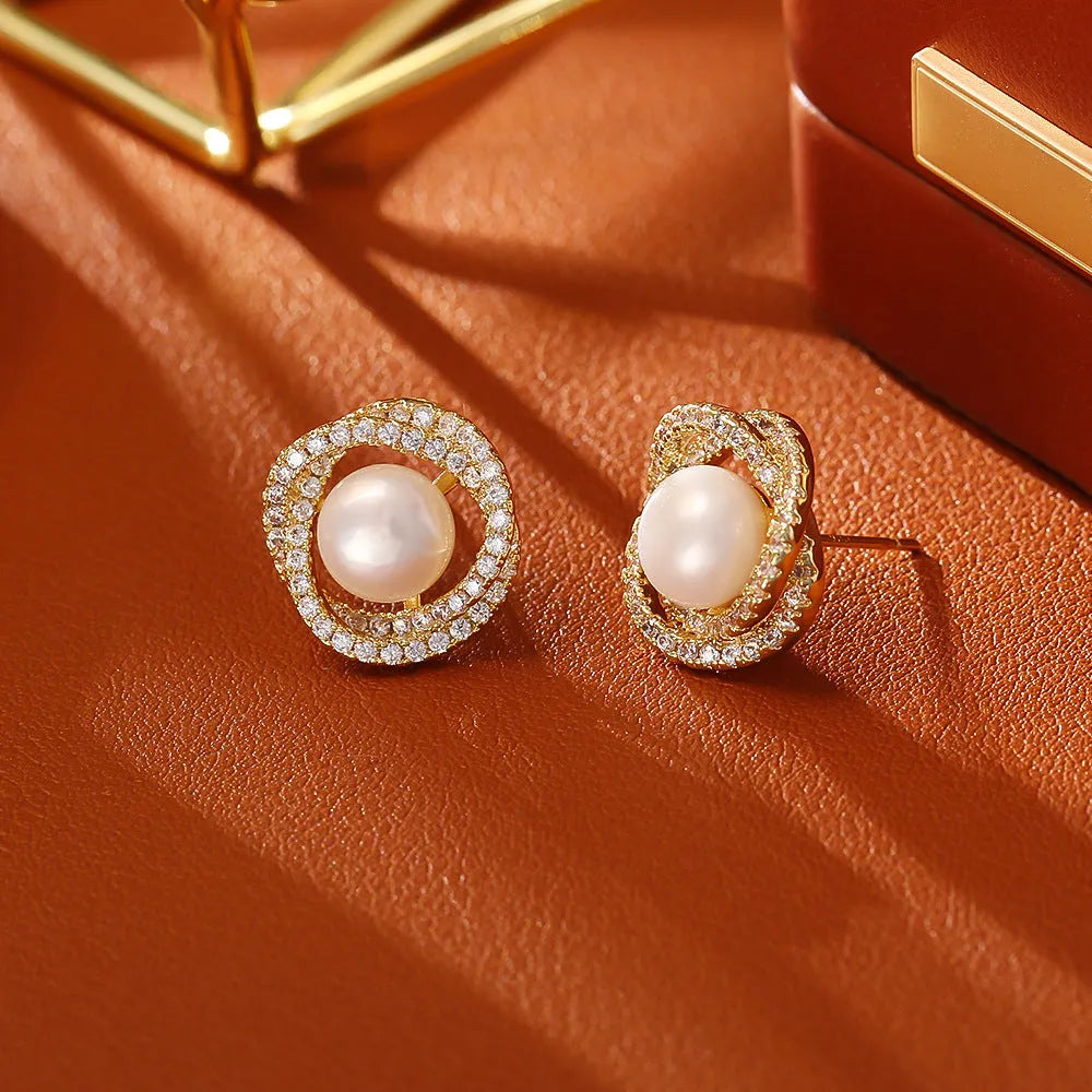 Natural pearl winding ear studs with real gold plating on copper base geometric round design