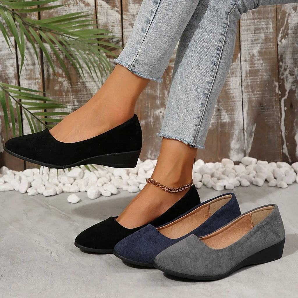 Women's light brown suede wedge pumps with a pointed toe and shallow mouth design on a rubber sole.