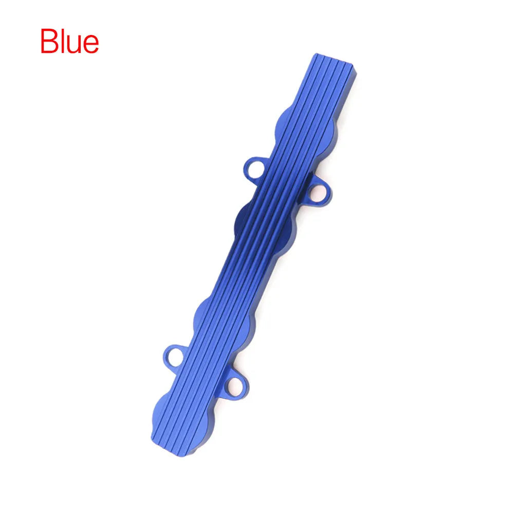 Aluminium alloy engine wiring harness housing cover in blue, red, and silver finishes.