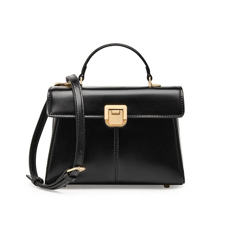 Women's black leather shoulder bag with vachette clasp showing horizontal square shape and adjustable strap