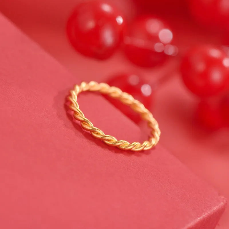 Brass gold plated women's ring showing twist, matte and glossy simple bracelet styles