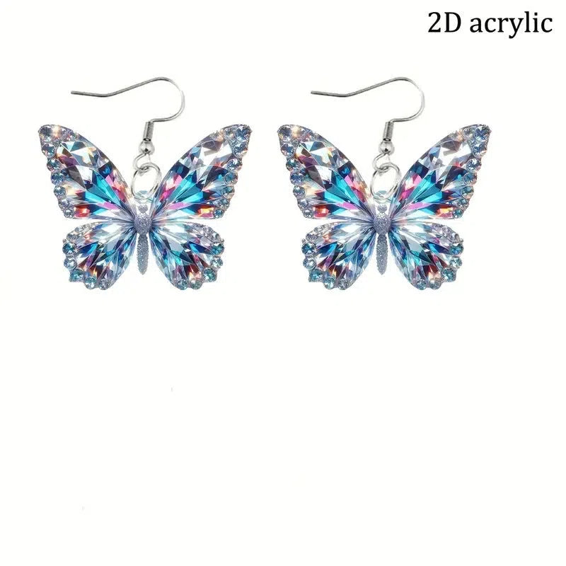 Colourful printed 2D acrylic earrings with butterfly design on a light background