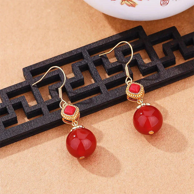 Southern Red Agate round bead earrings with S925 silver inlaid jasper detail in geometric copper alloy design