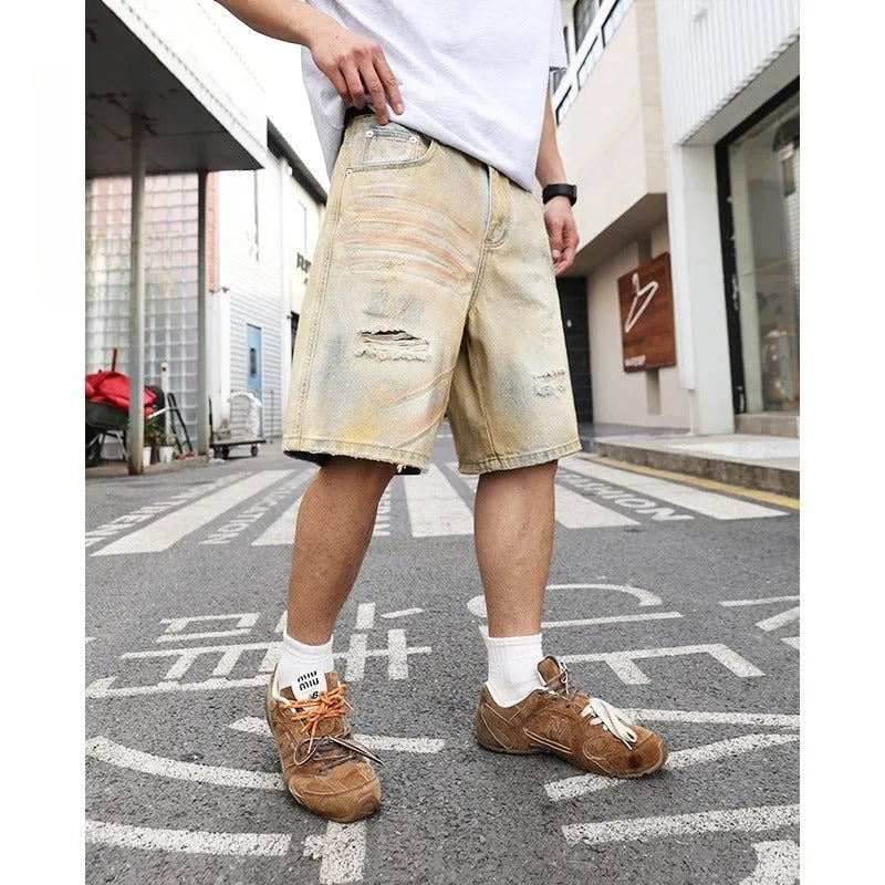 Men's light blue ripped denim shorts showing straight-leg design and mid waist fit