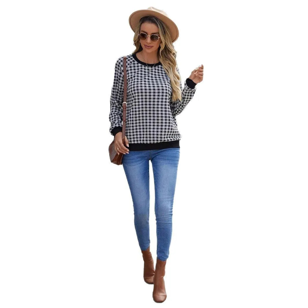 Black long sleeve pullover sweater with plaid stripes and printed pattern on a mannequin.