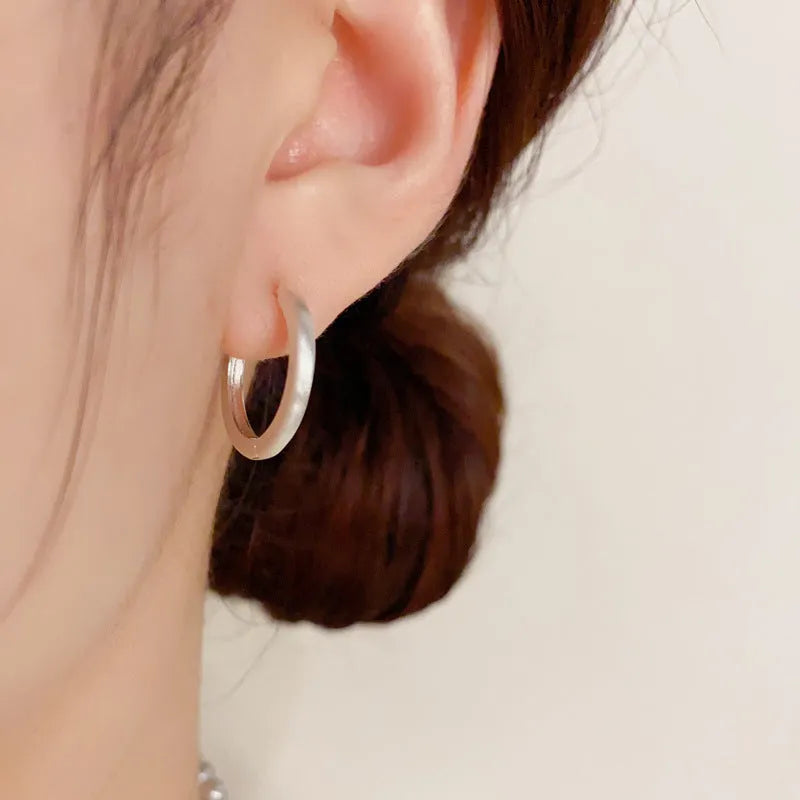 Women's geometric round ear clips with gold plating on copper in gold and silver colour options