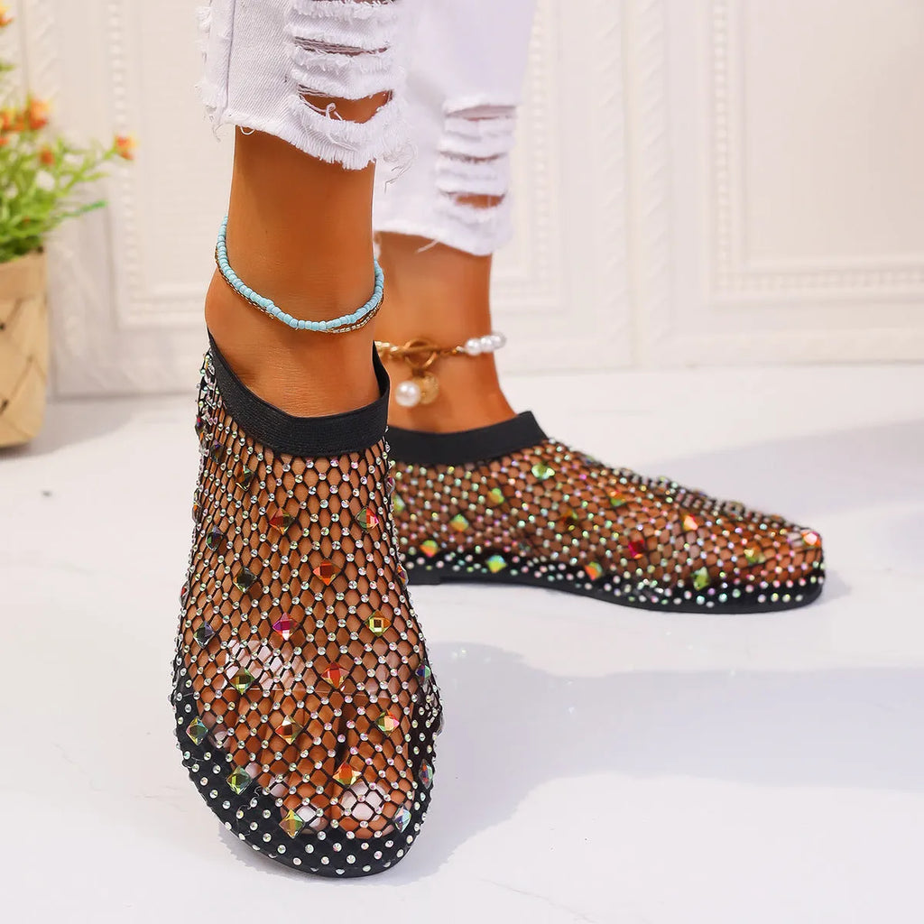 Colourful rhinestone detail on the mesh upper of women's white flat sandals with a round toe.