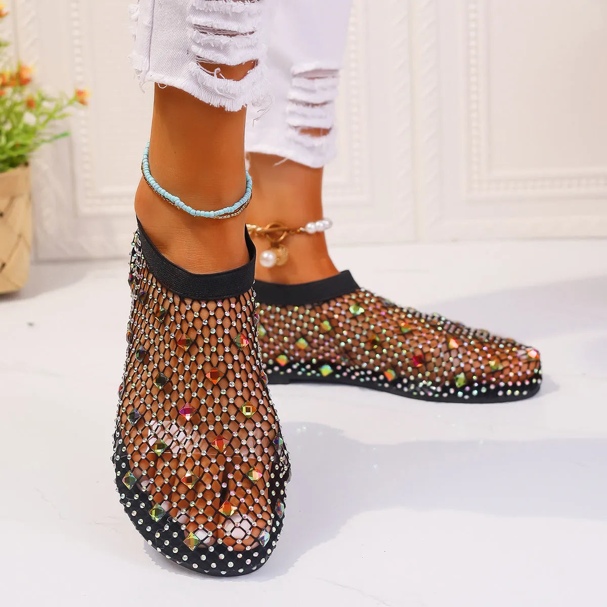 Colourful rhinestone detail on the mesh upper of women's white flat sandals with a round toe.