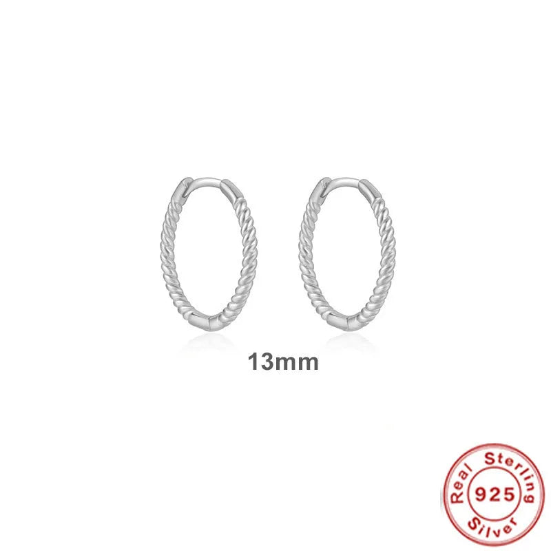 A pair of S925 sterling silver twisted string round hoop earrings on a gold background.