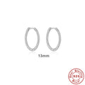 A pair of S925 sterling silver twisted string round hoop earrings on a gold background.