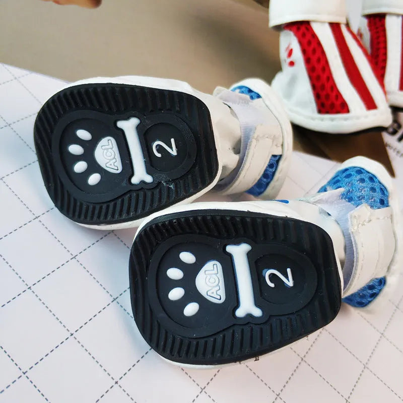 Set of four blue cloth dog shoes with zippers for small breed pets on a white background