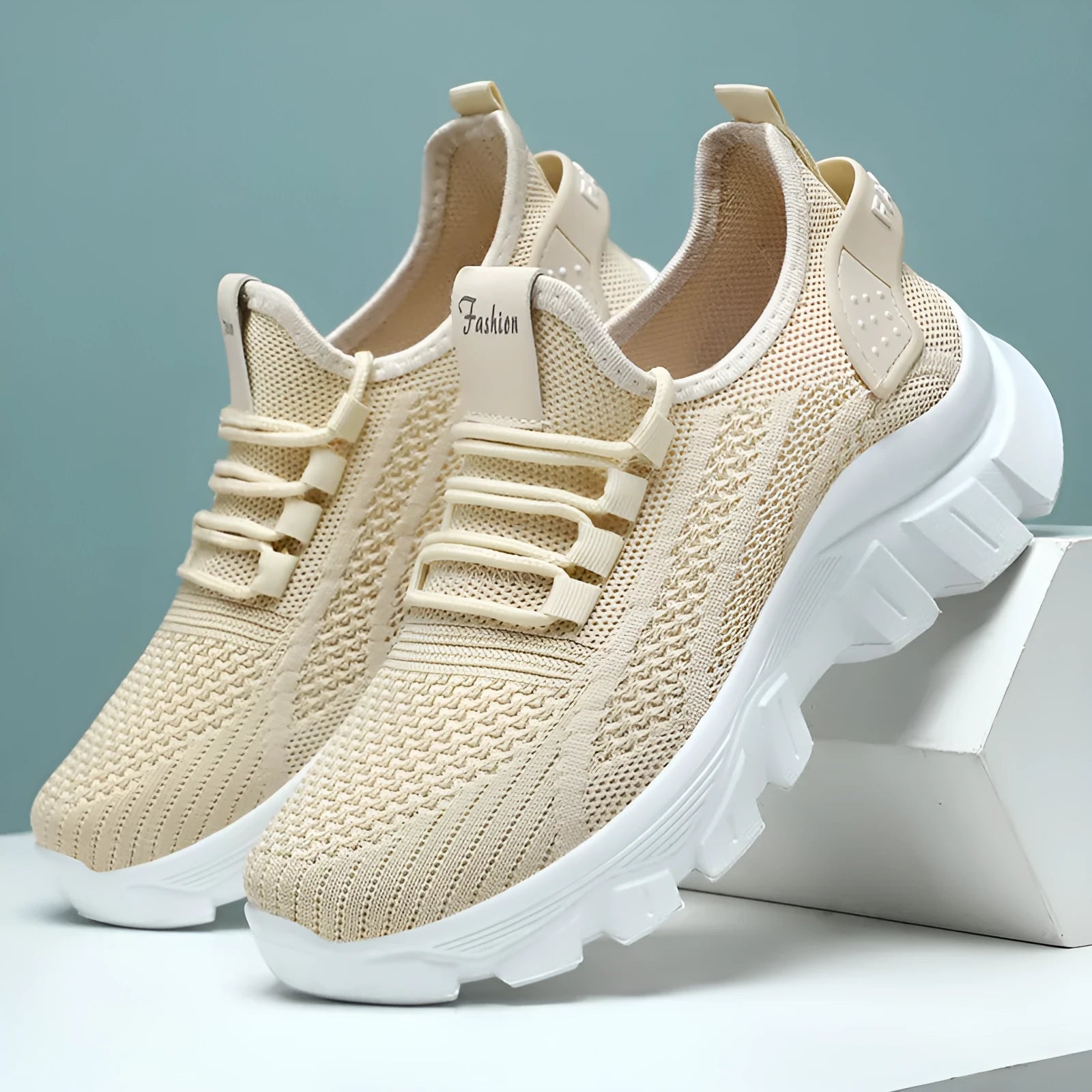 Women's white Flyknit lace-up sneakers with a thick PVC sole and round toe on a neutral background.