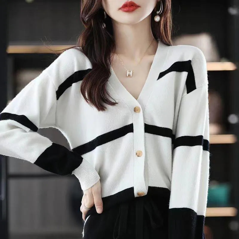 Women's black and white striped knitted cardigan with 3D pattern, V-neck, and button-up front.