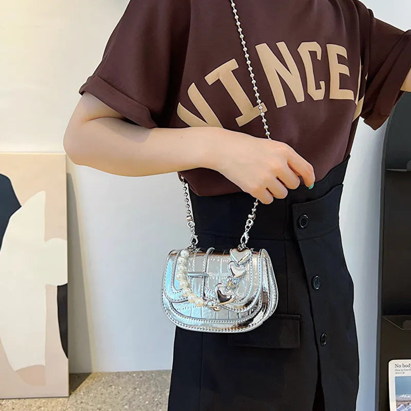 Silver laser pearl tote saddle mini crossbody bag for women on a model