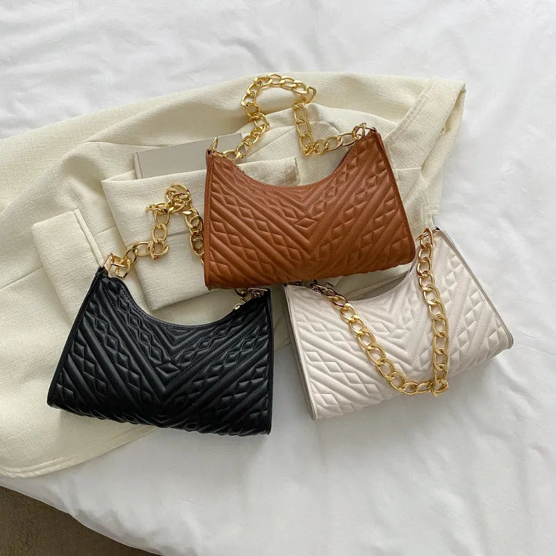 Brown pleated chain baguette shoulder bag showing vertical square shape and adjustable strap