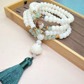 White Jade Bodhi beaded bracelet with 108 beads in a unisex design on a wrist.