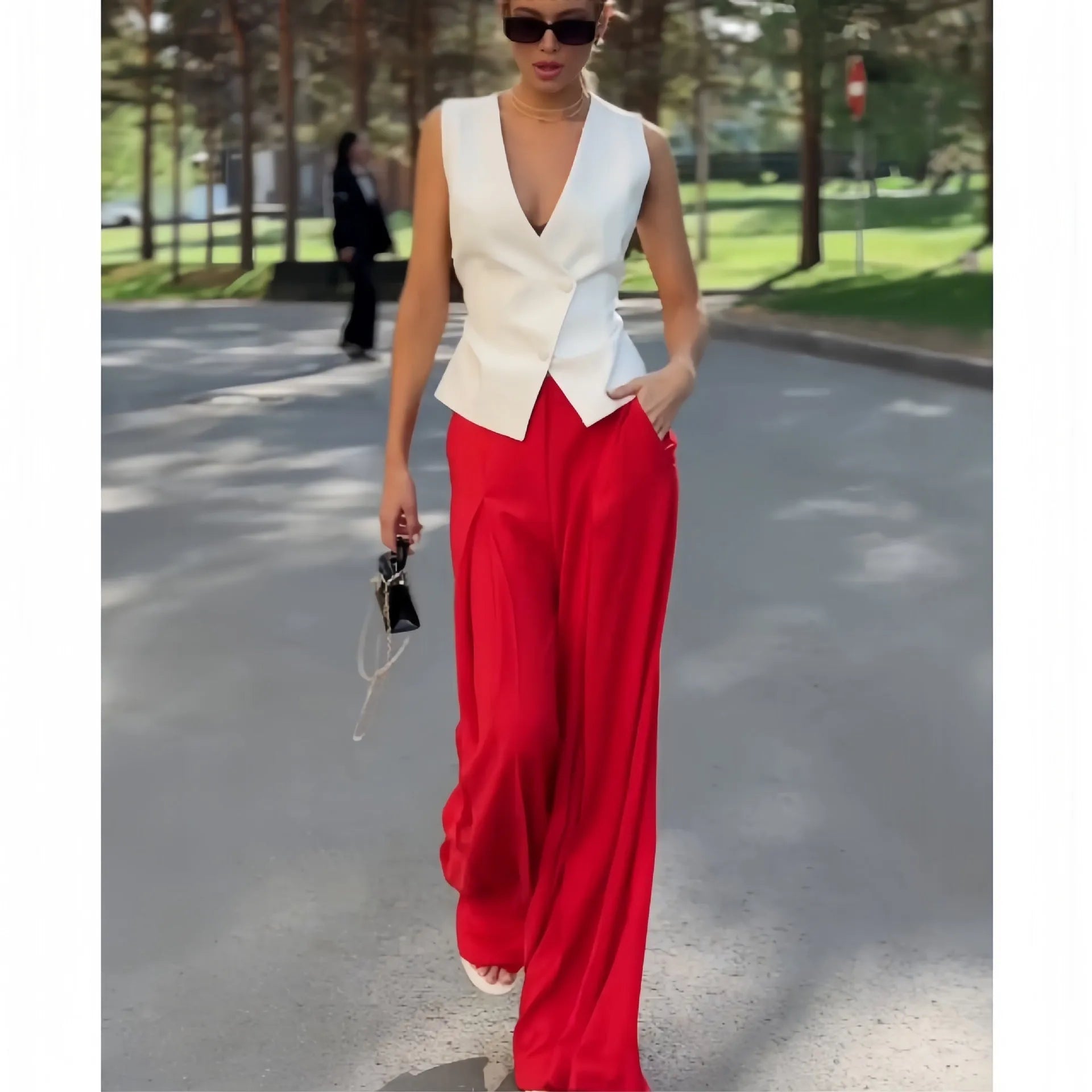 Women's beige two-piece set with deep V-neck sleeveless top and wide-leg trousers