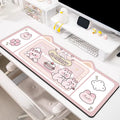 Oversized solid colour desk pad with optional pink bunny, purple bear, or purple kitten patterns on natural rubber base.