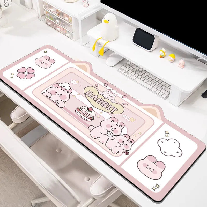 Oversized solid colour desk pad with optional pink bunny, purple bear, or purple kitten patterns on natural rubber base.