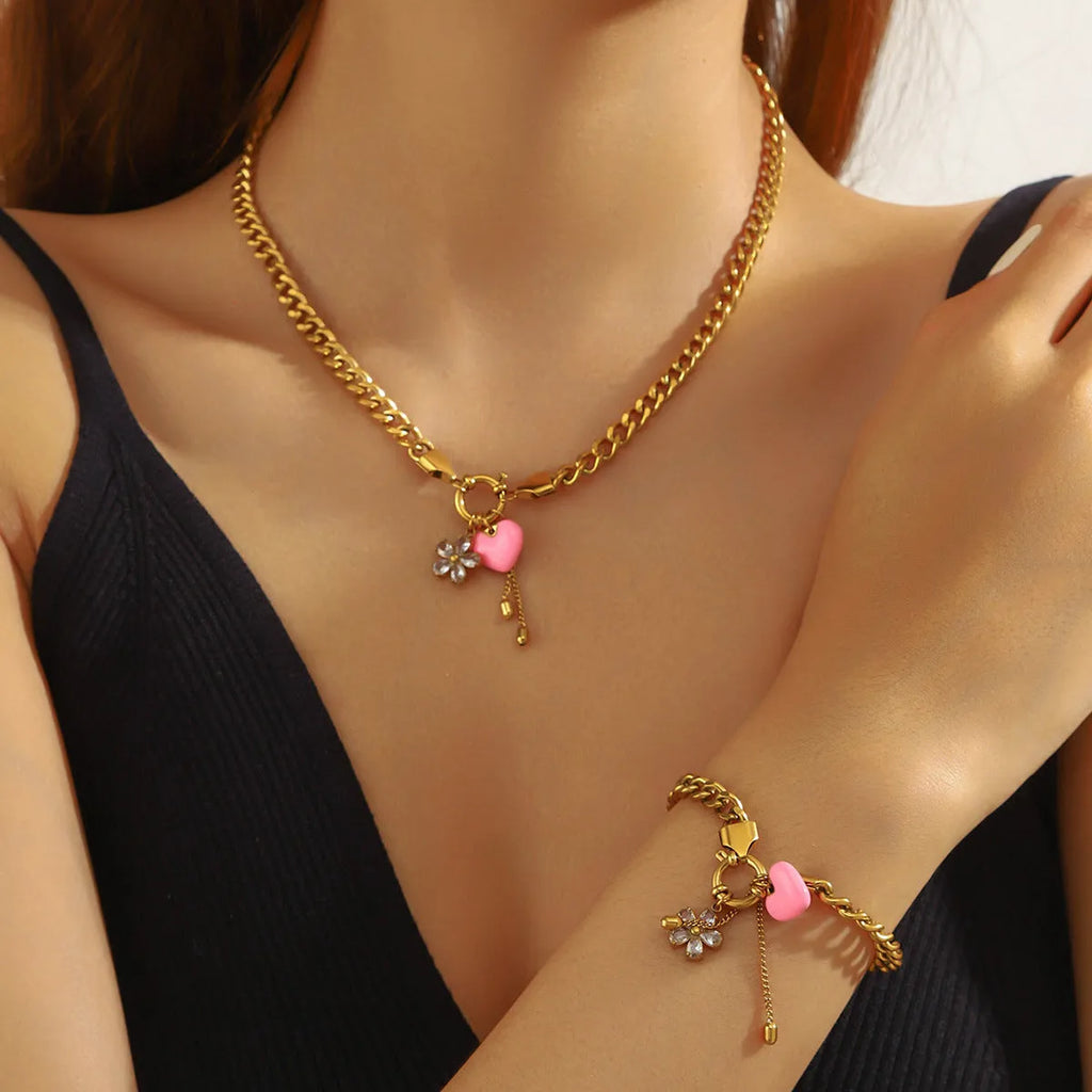 Tassel stainless steel bracelet and necklace set for women with flower and butterfly motifs on a white background