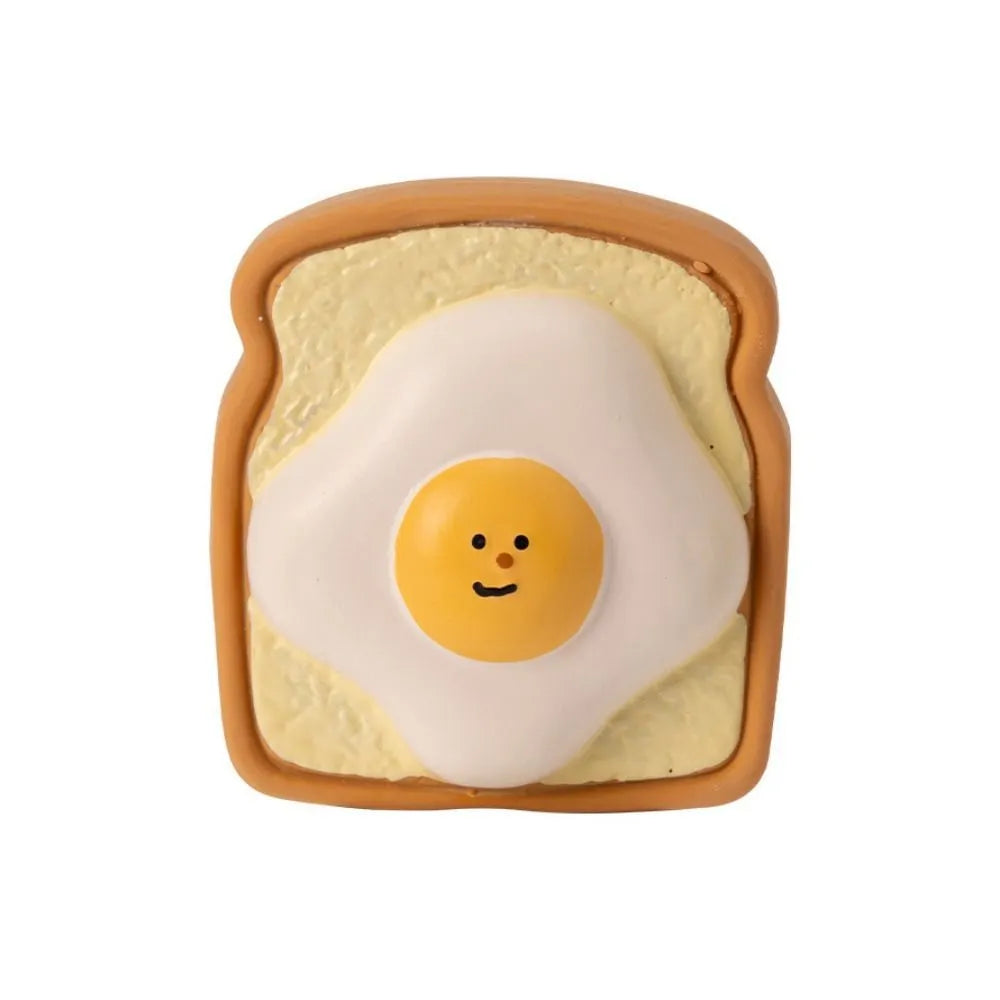 Yellow or green cartoon bread-shaped latex chew toy for dogs with a squeaker inside.