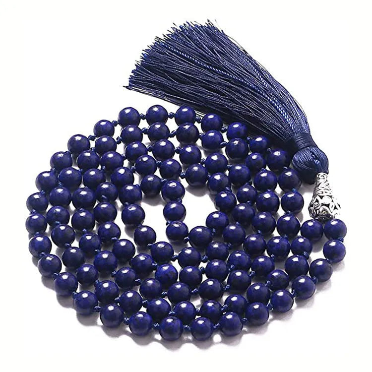Long multicoloured agate tassel necklace with geometric beads and a flowing pendant.