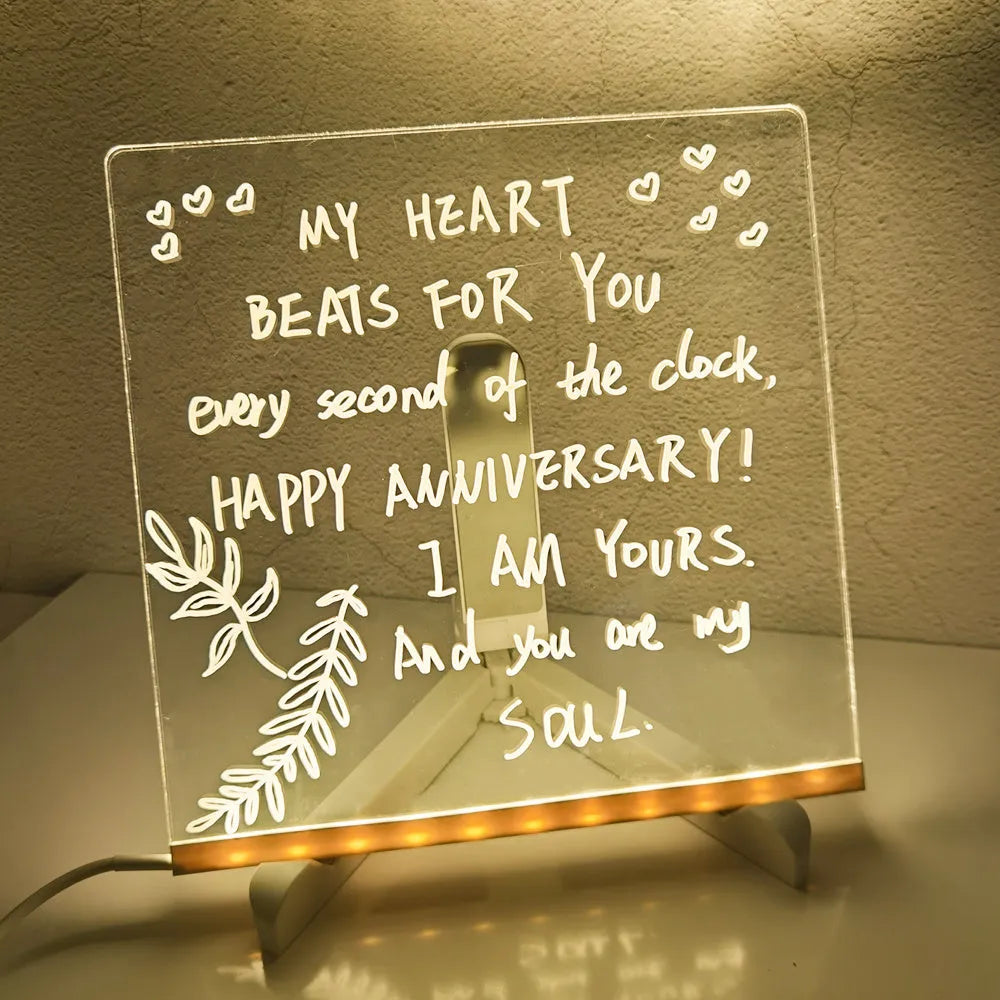 Acrylic DIY note board LED night light with USB cable, bracket, and colourful pens on a desk