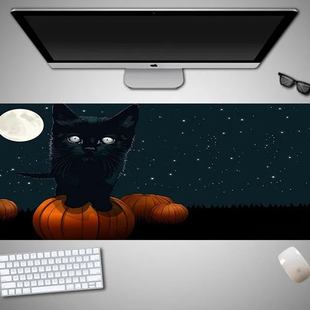 Oversized Halloween-themed computer mouse pad with non-slip rubber cloth backing on wooden desk