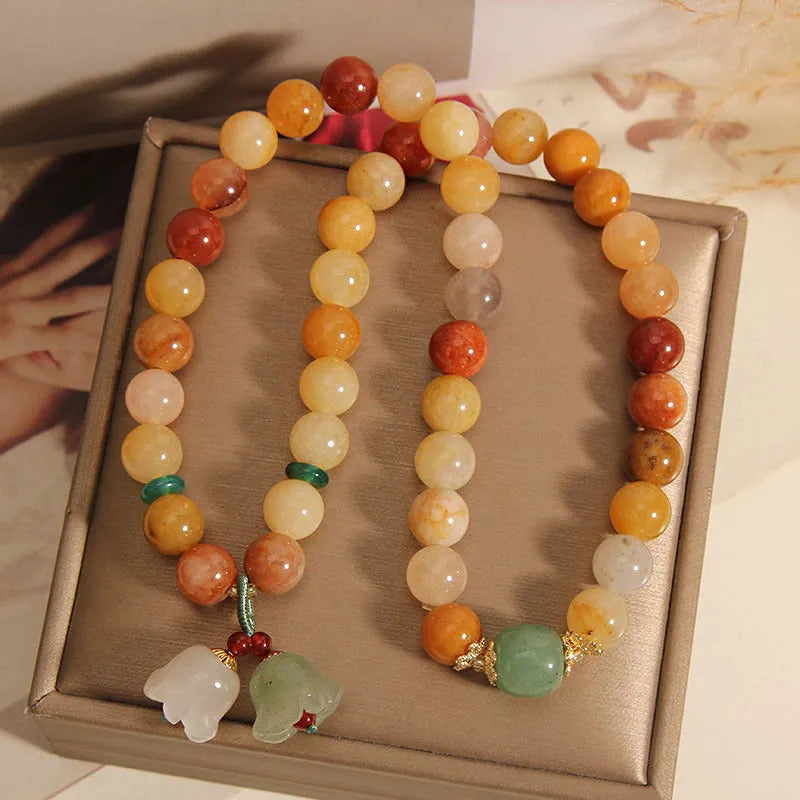 Women's natural jade multi-layer bracelet with orchid pendant on wrist