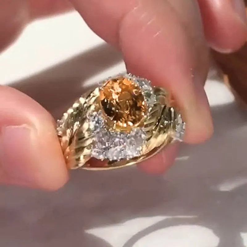 Copper feather embossed ring with yellow zircon stones, showing geometric design detail