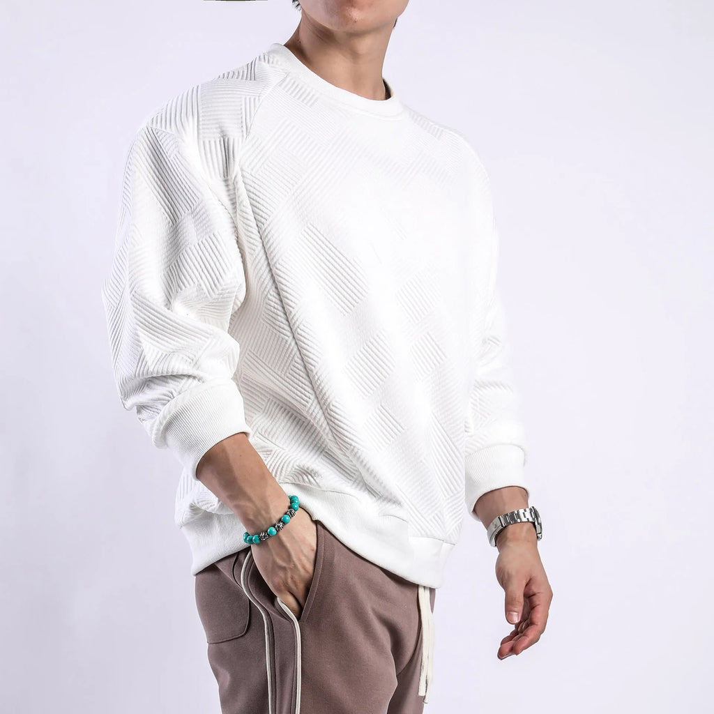 Man wearing a loose fit Army Green long sleeve twill jacquard pullover sweater.