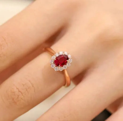 Gold Pigeon women's silver ring with red gemstone and floral gold inlaid pattern.