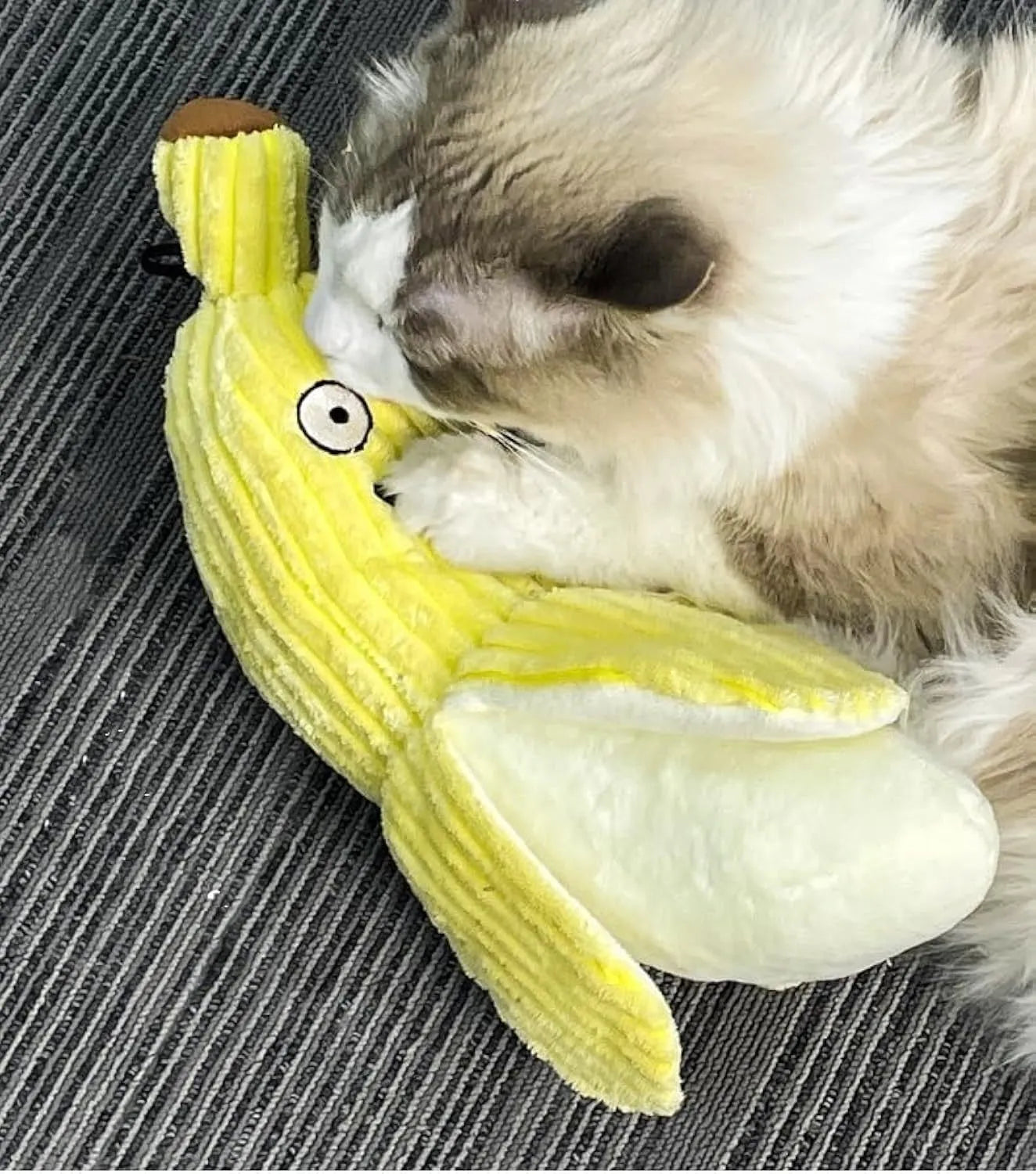 Yellow banana-shaped cat toy with soft plush texture and crinkle paper sound element