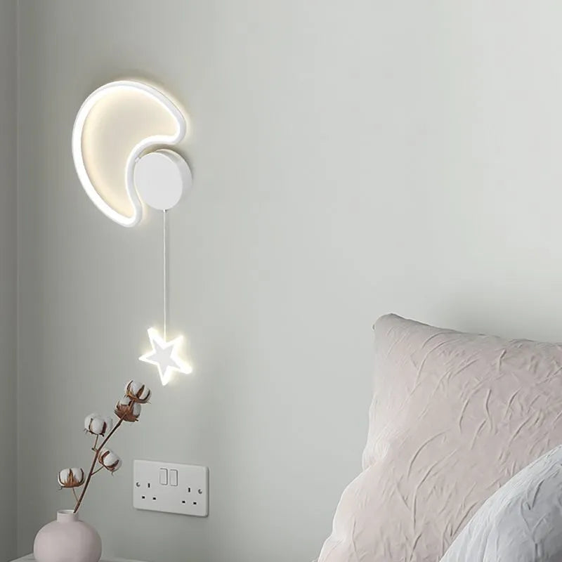 White cloud-shaped children's wall lamp with 3-colour LED light mounted beside a bed.