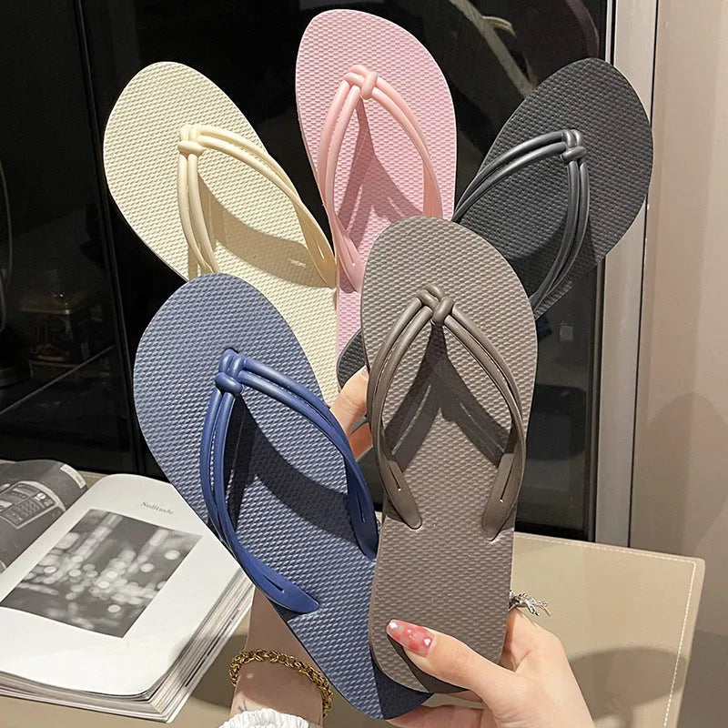Men's PVC toe-covering flip flops on a solid colour background, showing the non-slip sole and range of available colours.