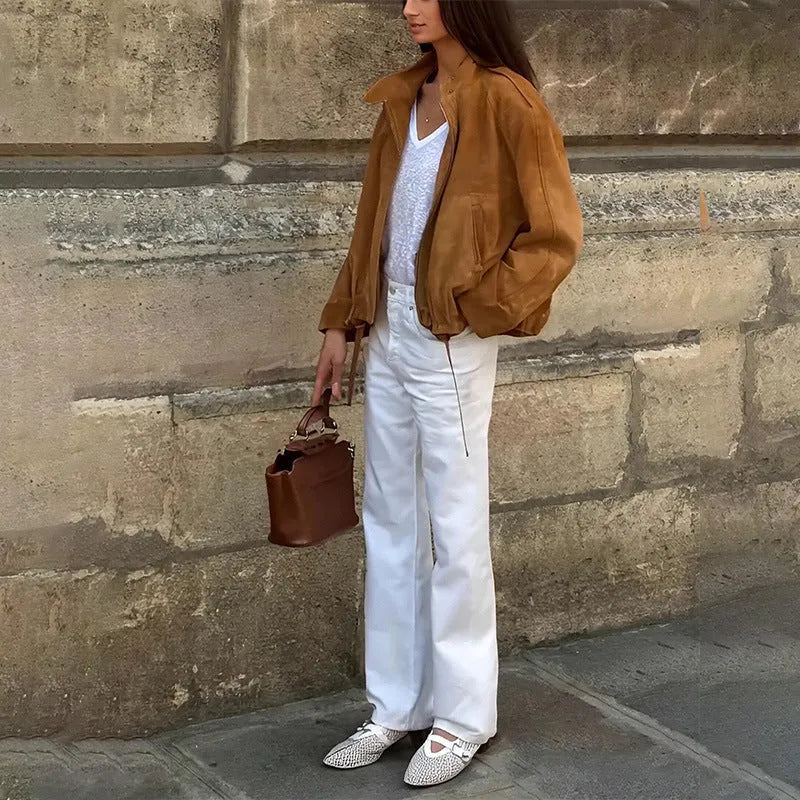 Man wearing a solid colour loose-fit long sleeve retro-style polyester jacket.