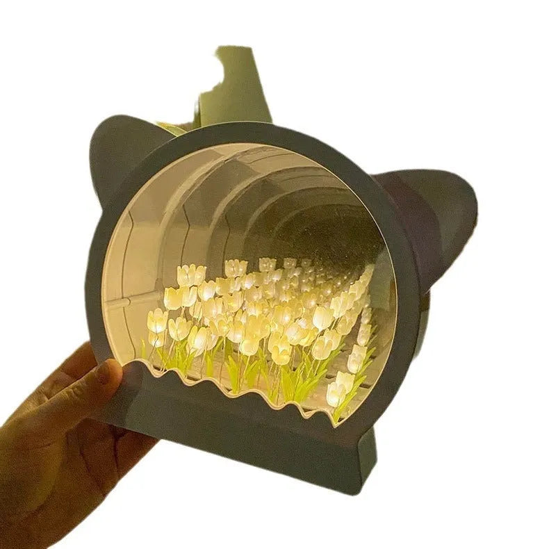 Handmade DIY cat head shaped night lamp with colourful tulip flowers on a blue background
