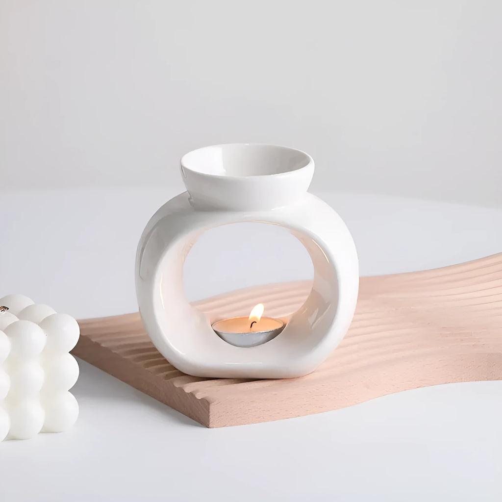 White Nordic style ceramic aromatherapy stove ornament on a wooden surface